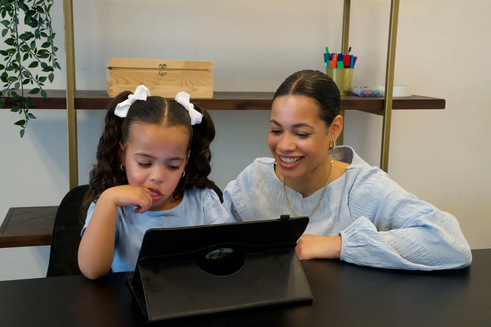 Parent teaching children with WLearn materials